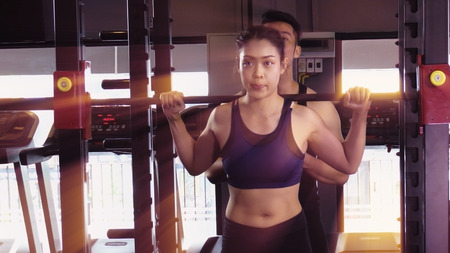 Exercise in the gym, man and women want to have a beautiful body with fitness.の写真素材