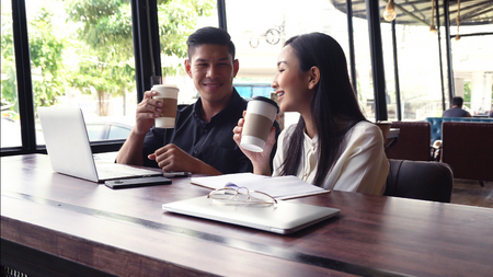 Young adults Make an appointment and work in the coffee shop.の写真素材