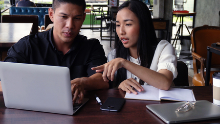 Young adults Make an appointment and work in the coffee shop.の写真素材