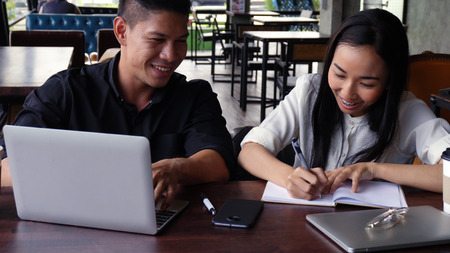Young adults Make an appointment and work in the coffee shop.の写真素材