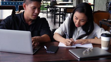 Young adults Make an appointment and work in the coffee shop.の写真素材