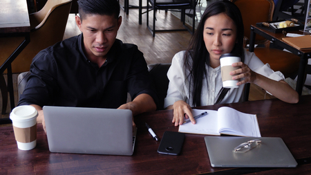 Young adults Make an appointment and work in the coffee shop.の写真素材