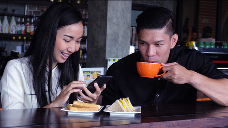 Young adults Make an appointment and work in the coffee shop.の写真素材