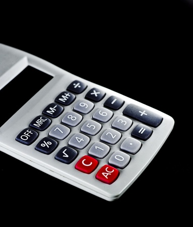 White calculator with black background.の写真素材