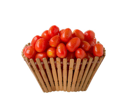 Tomatoes in basket on white backgroundの写真素材