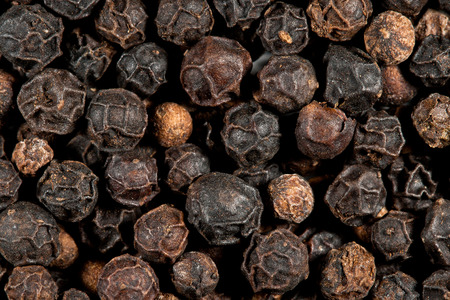 Black peppercorn background, macro