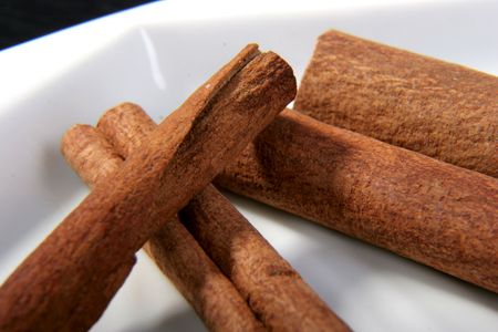cinnamon sticks for tea and coffee aromatization on the white plate