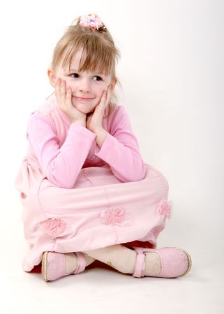isolated happy little girl in pink dressの写真素材
