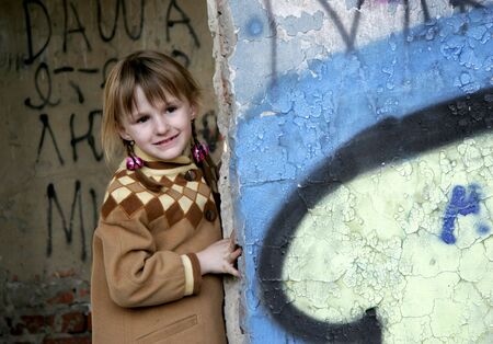 smiley little girl in ruins with painted wallsの写真素材