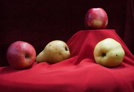still life with red and yellow apples and pearの写真素材
