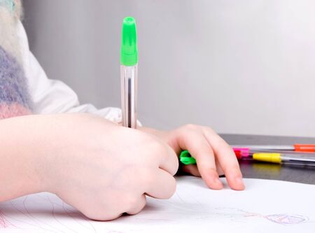 the small child hands drawing princess on white paperの写真素材