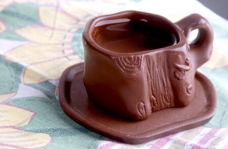 the clay cup of tea on clay saucerの写真素材