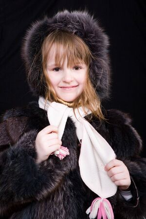 studio portrait of little girl in black furの写真素材