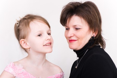 mother and her daughter in pink festive dressの写真素材