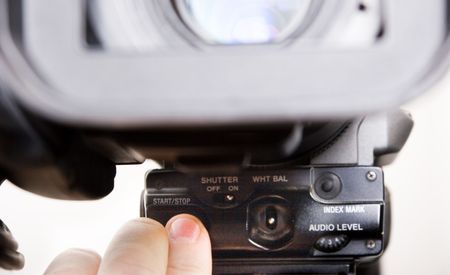 cameraman push the start rec button in front of dv-cam cameraの写真素材