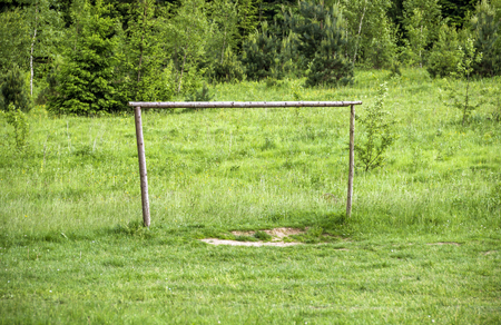 the primitive handmade wooden footbal goal at the meadowの写真素材