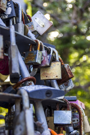 close-up of many different closed lovelocks at the bridgeの写真素材