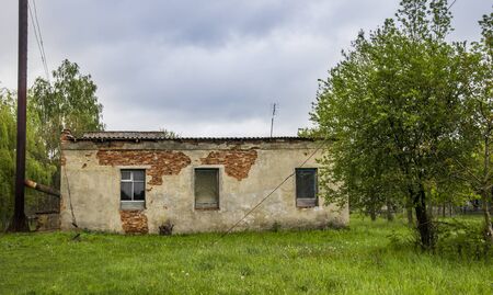 a brick barn in countryside with broken walls and windowsの写真素材
