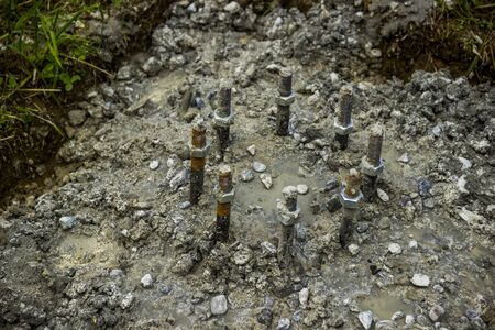 close-up of the steel bolts and nuts in cocrete baseの写真素材