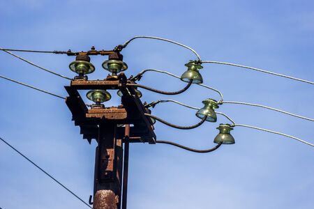 close-up of the old iron pole with electric wires