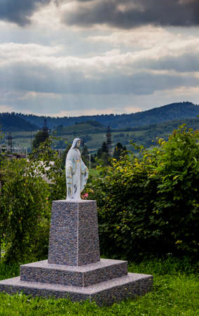 statue of Virgin Mary near the Ukrainian autocephalous Orthodox church of St.Nicholas in Skhidnytsa, Lviv region of Western Ukraineの写真素材