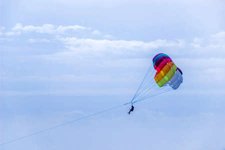 a silhouette of people parasailing with colorful parachute under the Black Sea, Ukraineの写真素材