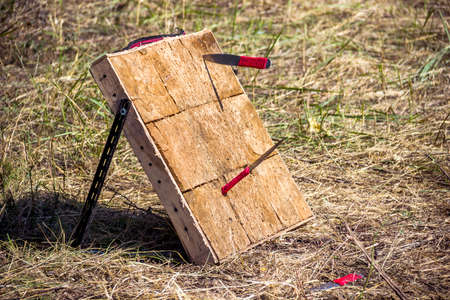 close-up of a wooden target and throwing knivesの写真素材
