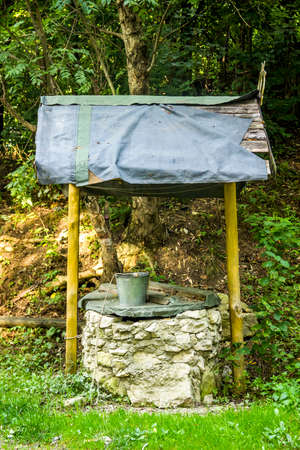 close-up of old draw well and bucket in Ukrainian villageの写真素材