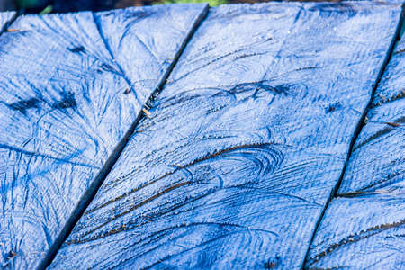 close-up of a wooden table with morning frostの写真素材