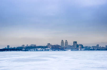 Ukrainian city Dnipro on big frozen river Dnipro in winterの写真素材