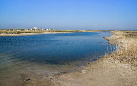 a shallow salty lagoon near the sea on the Arabat Spit on the Sea of â€‹â€‹Azov, Ukraine