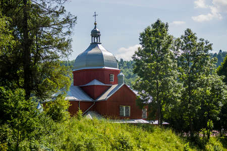 a wooden St.Nicholas Church in Urych village near the Tustan fortress rocks, Lviv region of Ukraineのeditorial素材