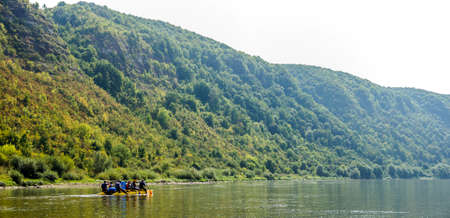 a Dnister river landscape with people on sport catamaran, National Nature Park Dnister Canyon,...
