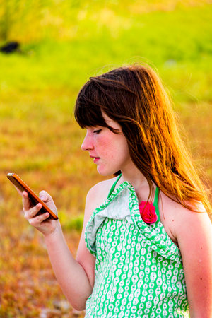 close-up of a teenage girl look in smartphoneの写真素材