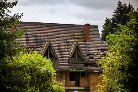 close-up of a damged roof of the unfinished cottage in Ukrainian Carpathian villageの写真素材