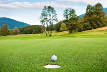 golf ball on tee in a beautiful golf clubの写真素材