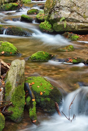 beautiful cascade waterfall in autumn forestの写真素材