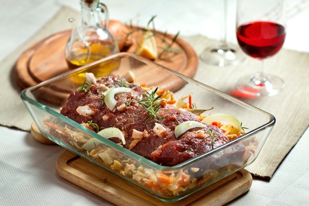 fresh raw deer meat in a glass bowlの写真素材