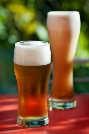 Two glasses of beer with frothの写真素材