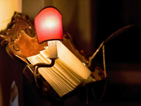 Old book in library with small lampの写真素材