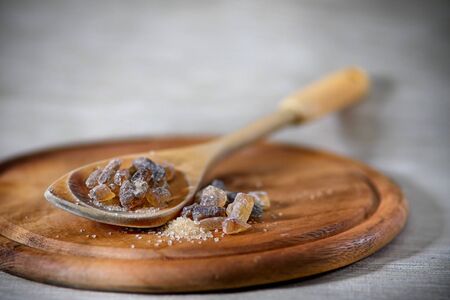 Brown cane sugar on the spoonの写真素材