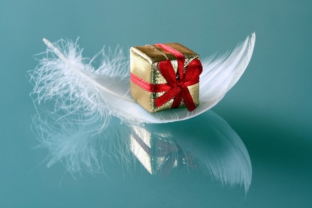Small romantic present on white feathersの写真素材