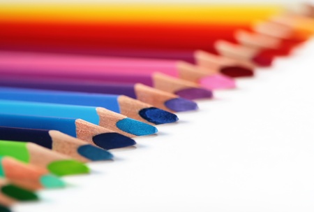 Assortment of colored pencils with shadow on white background - colored crayons