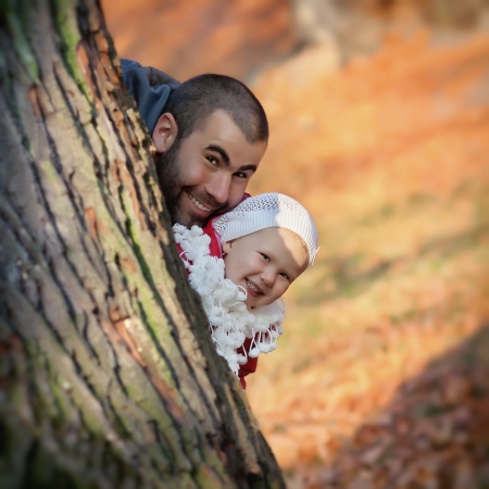 Happy father and daughter playing in the parkの写真素材