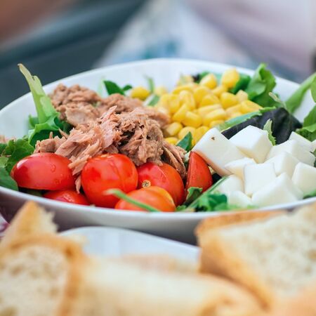 Tasty salad with tuna, tomato and cornの写真素材