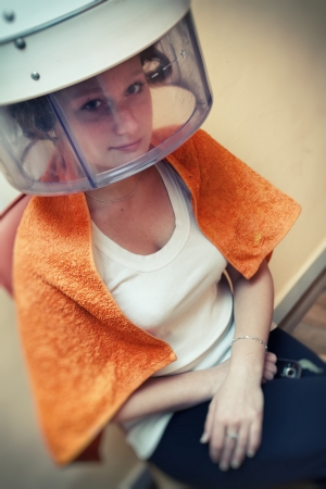 Woman drying hair at the hairdresserの写真素材