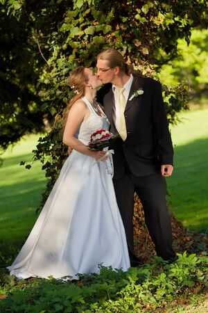 Elegant bride and groom posing together outdoors on a wedding day の写真素材