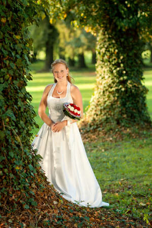Beautiful bride portrait with flower in park の写真素材