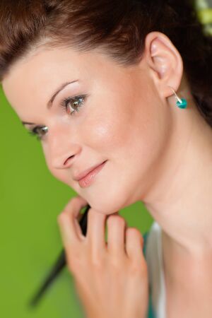 Young happy beautiful woman with makeup brushの写真素材
