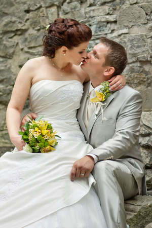 Elegant bride and groom posing together outdoors on a wedding day の写真素材